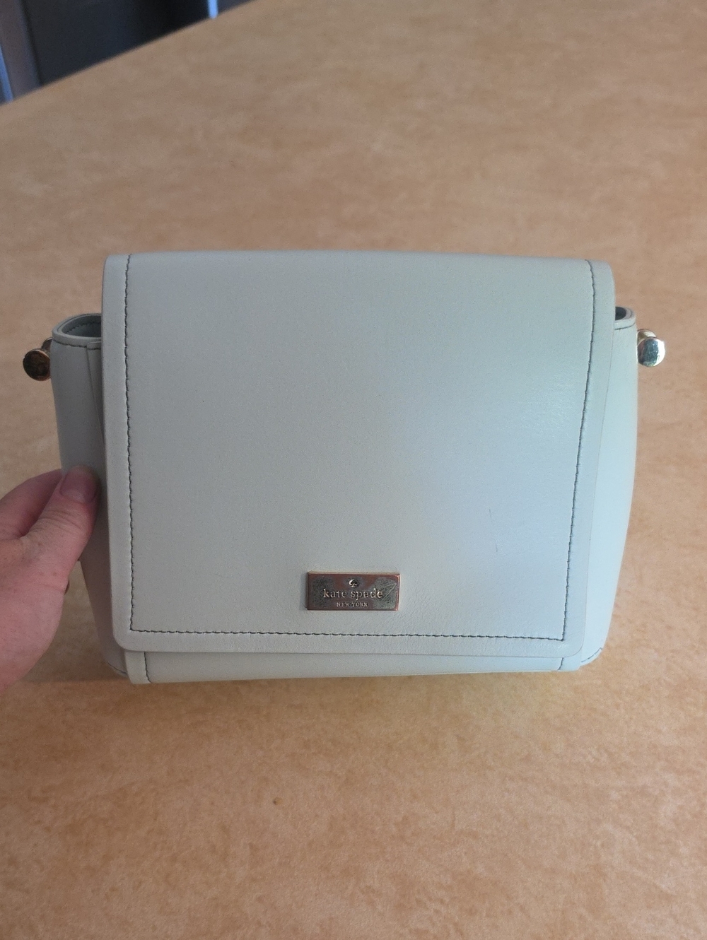 kate spade pale cream leather flap crossbody with gold plaque